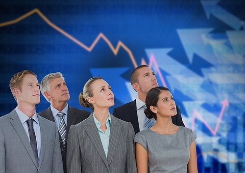 Digital composite of Business Team Standing in front of Graph against blue background