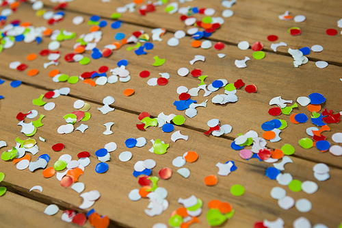Close-up of confetti on wooden surface
