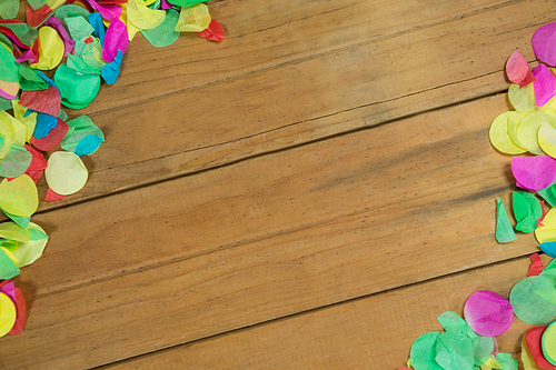 Overhead of confetti on wooden surface