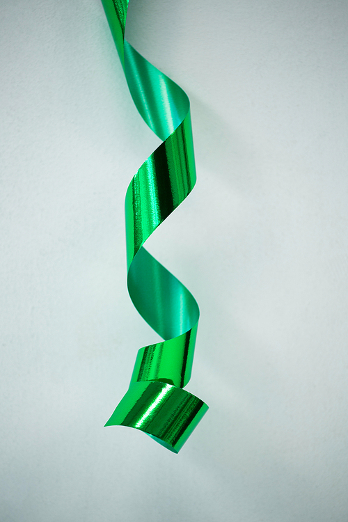 Close-up of green streamers on white background