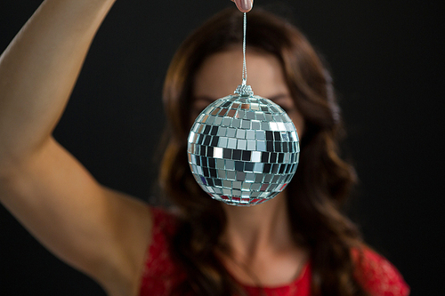 Close-up of woman holding mirror ball
