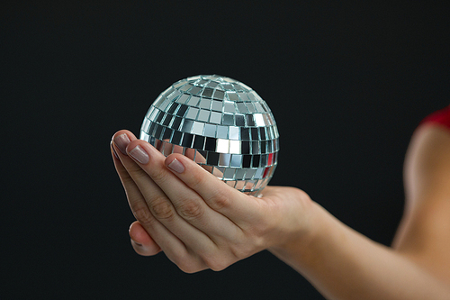 Close-up of woman holding mirror ball