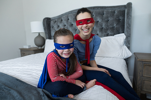 Portrait of mother and daughter pretending to be superhero