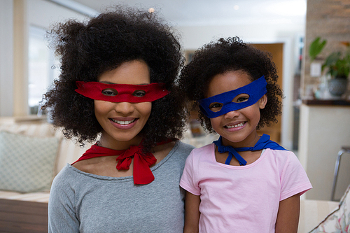 Mother and daughter pretending to be superhero at home