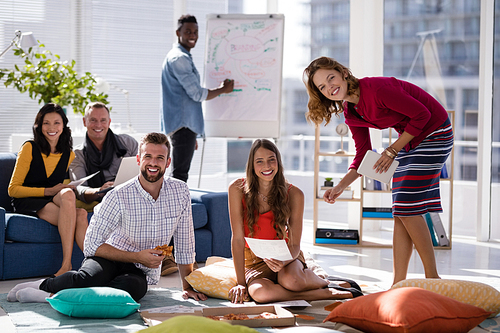 Portrait of happy executives working together in office