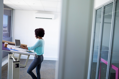 Female architect working over laptop in office