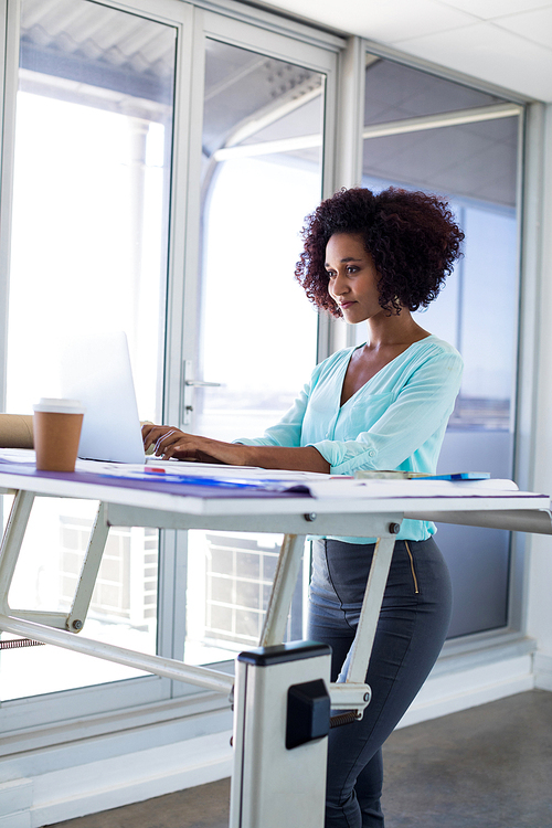 Female architect working over laptop in office