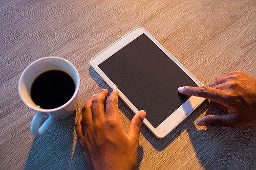 Male executive using digital tablet at his desk in office