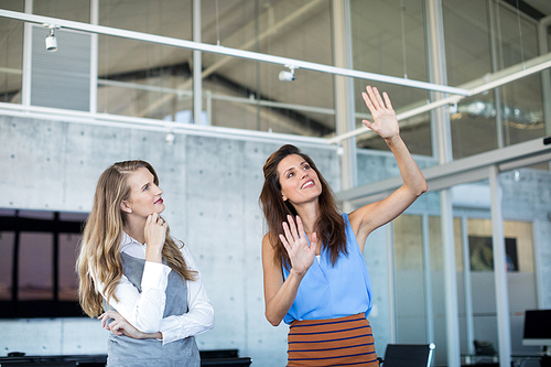 Female executives interacting with each other in office