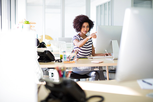 Female executive working at her desk in office