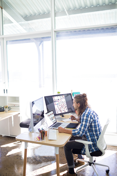 Male executive working at his desk in office