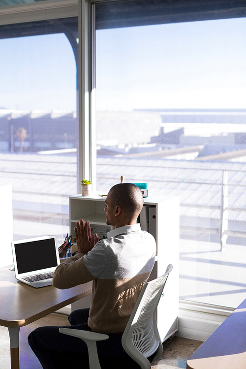 Male executive doing yoga in office