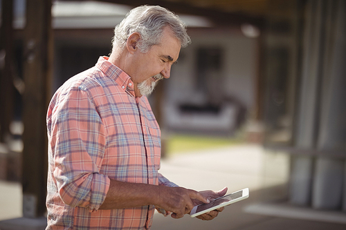 Senior man using digital tablet on a sunny day