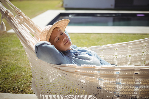 Senior woman relaxing on hammock on a sunny day