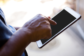 Cropped hand of senior man using digital tablet at nursing home