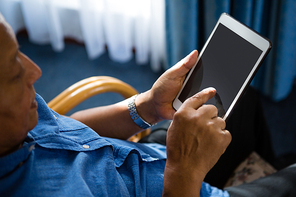 High angle view of senior man using digital tablet at nursing home