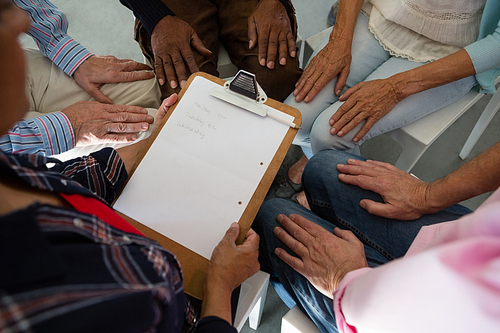 Close up of senior adults siting during discussion in art class