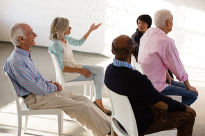 Senior people sitting on chair in art class