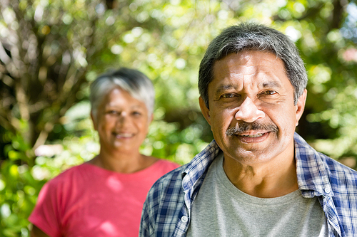 Portrait of senior couple in garden on a sunny day