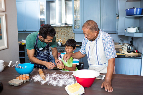 High angle view of family preparing food while standing in kitchen at home