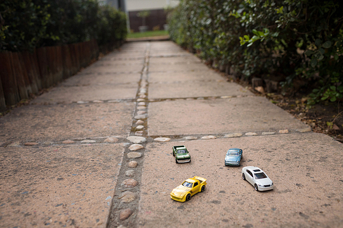 Close up of toy cars on footpath in yard