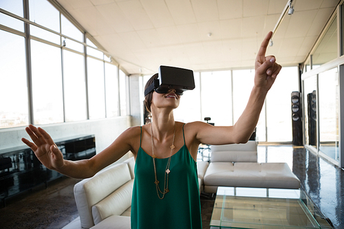 Young businesswoman using virtual reality simulator at office