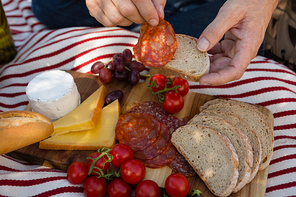 Mid-section of man having a meal in farm