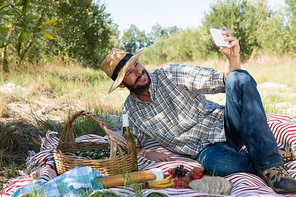 Man taking a selfie from mobile phone in olives farm