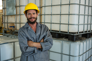 Portrait of worker standing with arms crossed in olive factory