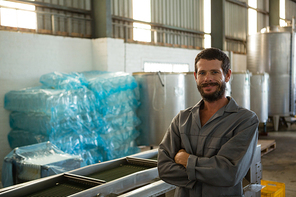 Portrait of worker standing with arms crossed in olive factory