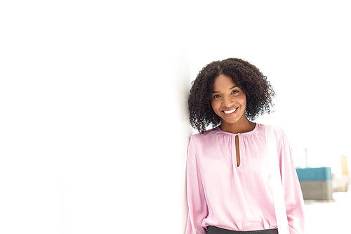 Front view of young pretty African-american employee  in modern office