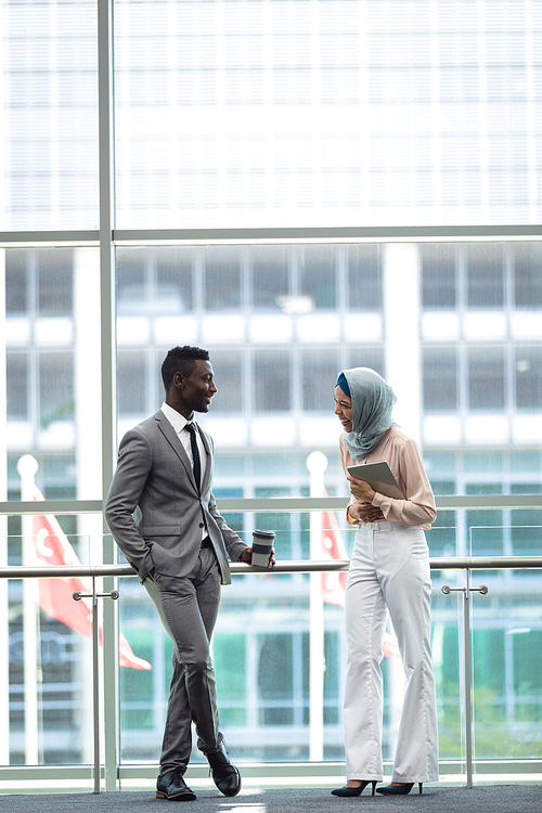 Side view of diverse young executives laughing in modern office