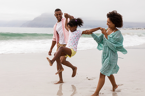 Side view of Happy African american family having fun together on the beach