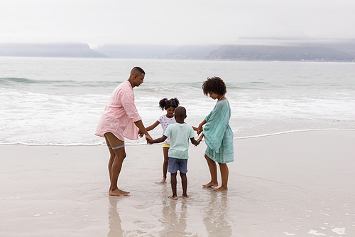 Side view of Happy African american family having fun on the beach