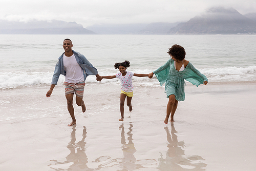 Front view of Happy African american family having fun together on the beach