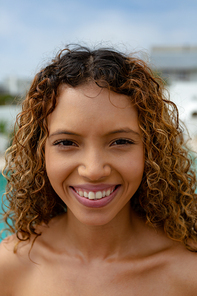 Portrait close-up of happy mixed-race woman . Summer fun at home by the swimming pool