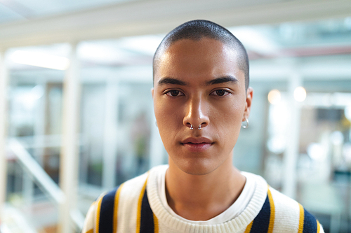 Portrait of mixed race male graphic designer standing in office. This is a casual creative start-up business office for a diverse team