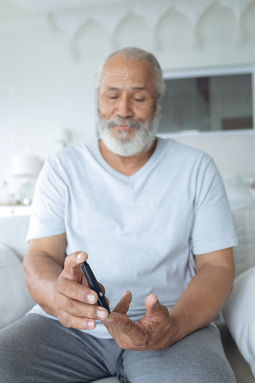 Close up of senior Caucasian man using an insulin pen. Authentic Senior Retired Life Concept