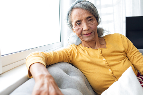 Front view of African American Woman inside a room smiling. Authentic Senior Retired Life Concept