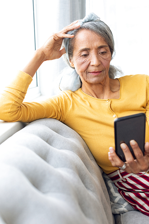 Front view of African American Woman using smartphone. Authentic Senior Retired Life Concept