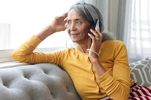 Front view of African American Woman talking on the phone. Authentic Senior Retired Life Concept