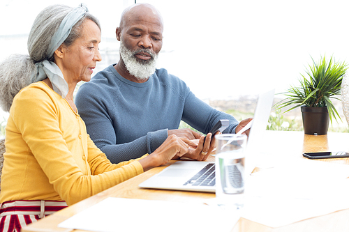 Side view of African American Couple calculating finances. Authentic Senior Retired Life Concept