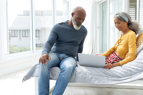 Side view of African American Couple standing close together while smiling. Authentic Senior Retired Life Concept