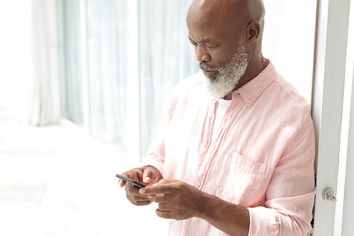 Side view of African American Man using smartphone. Authentic Senior Retired Life Concept