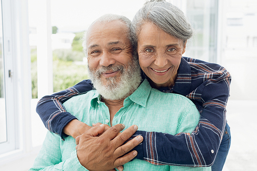 Portrait close up of African-American  couple hugging each other inside a room. Authentic Senior Retired Life Concept