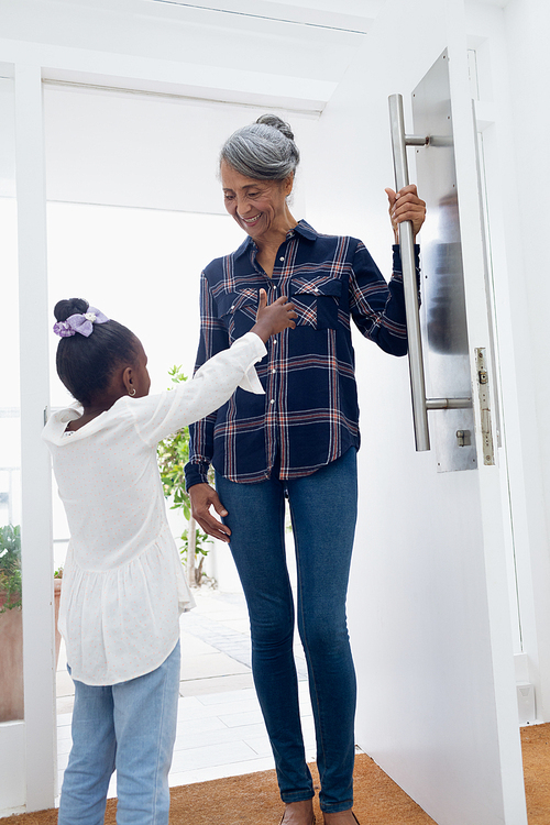 Side view of African american girls try to hugging her grandmother. Authentic Senior Retired Life Concept