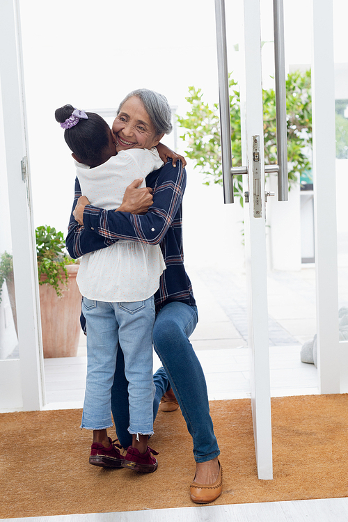 Front view of grandmother hugging her granddaughter. Authentic Senior Retired Life Concept