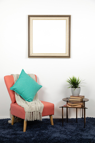 Blank picture in a frame hanging on the wall of a furnished domestic sitting room