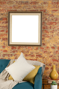 Blank picture in a frame hanging on the wall of a furnished domestic sitting room