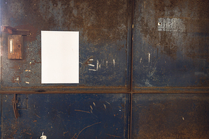 Close up of a blank sign hanging on a metal door